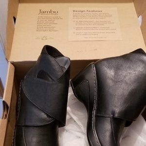 Black Vegan material  wih faux fur lining.  Memory foam footbed